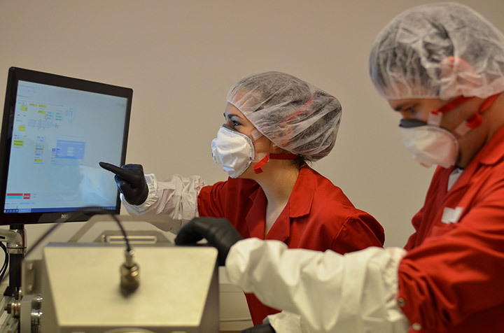 In protective gear, Bernadette Führer works with bioaerosols on the filter test rig set up as part of the "Aeropore" research project. Photo courtesy OFI