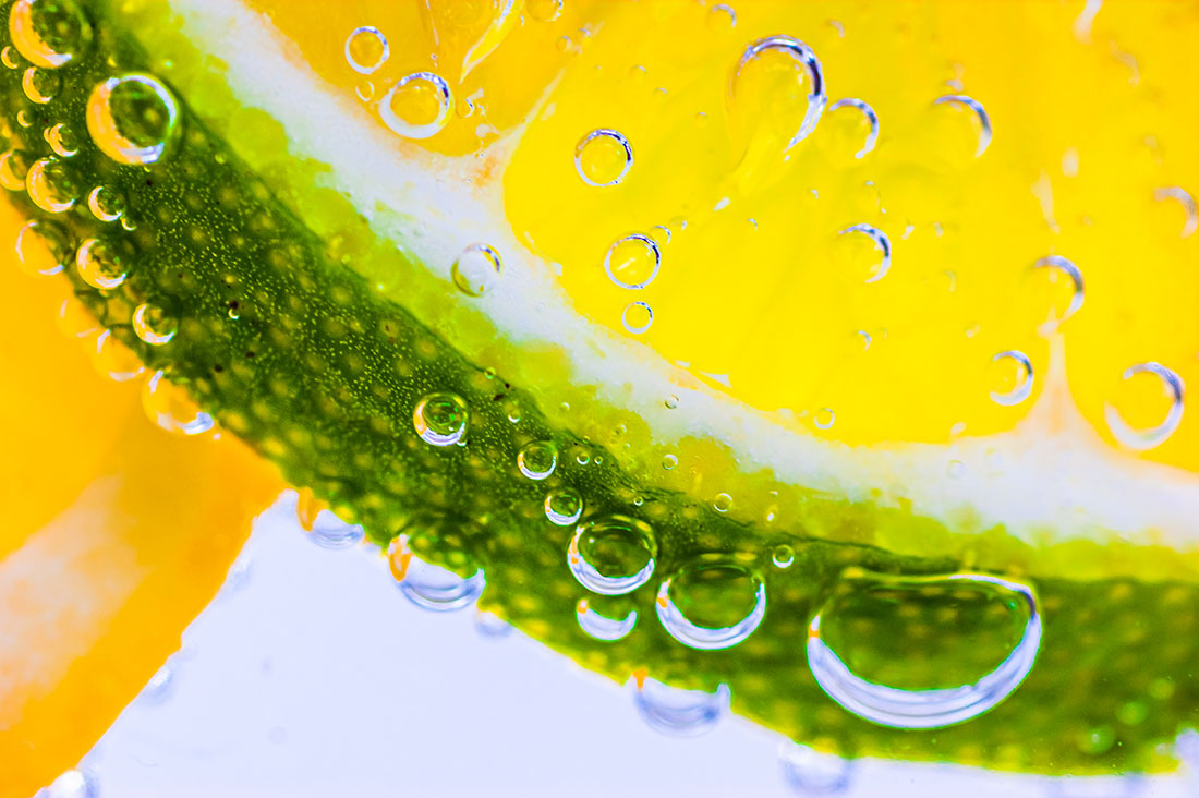 Citrus fruit in a glass of fizzy soda water. iStockphoto