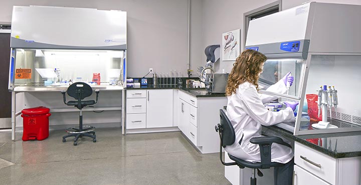 Nikki Sasher works in her lab area created during the COVID-19 pandemic to study particles and filtration. Photo courtesy of AAF Flanders