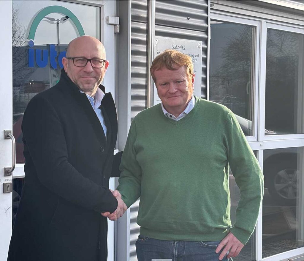 IFN's Global Correspondent Dr. Iyad Al-Attar (left) shakes hands with Professor Christof Asbach.