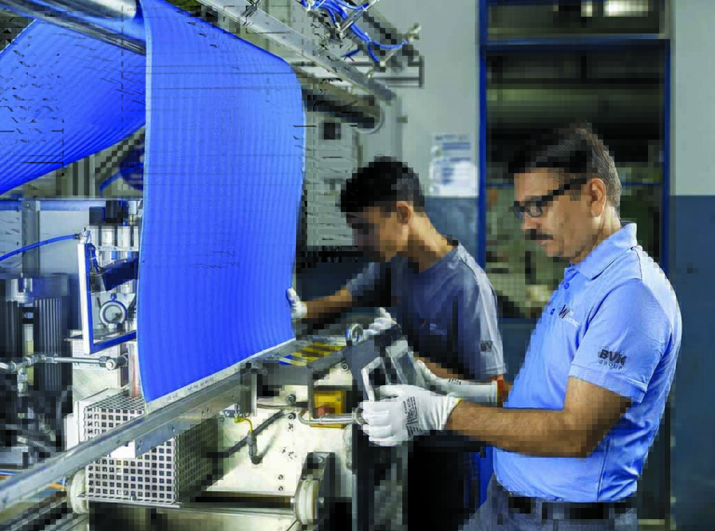 Operators using a patented clipper PAD seaming machine. Photo courtesy of BVK Group